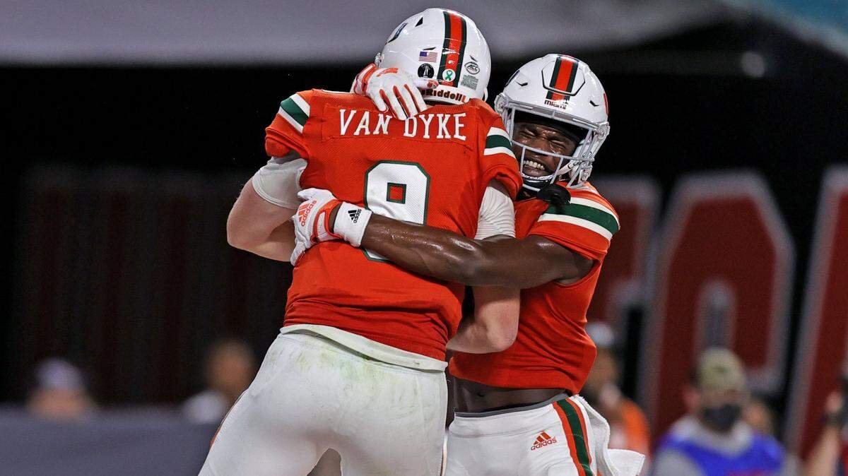 Miami Hurricanes quarterback Tyler Van Dyke (9) is congratulated by Key’Shawn Smith (5) after scoring a touchdown scores a touchdown during the fourth quarter of their ACC football game against the Virginia Cavaliers at Hard Rock Stadium on Thursday, September 30, 2021 in Miami Gardens, Florida.