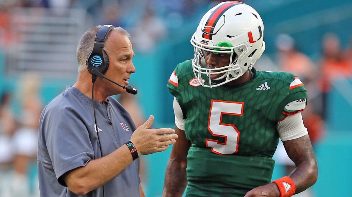 Miami Hurricanes Mark Richt talks with quarterback N'Kosi Perry between plays in the first quarter in their spring game at Hard Rock Stadium in Miami Gardens, April 14, 2018.