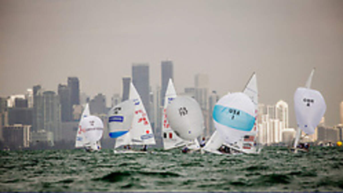 Men’s 470 fleet against the Miami skyline at Hempel World Cup Series Miami sailing regatta.
