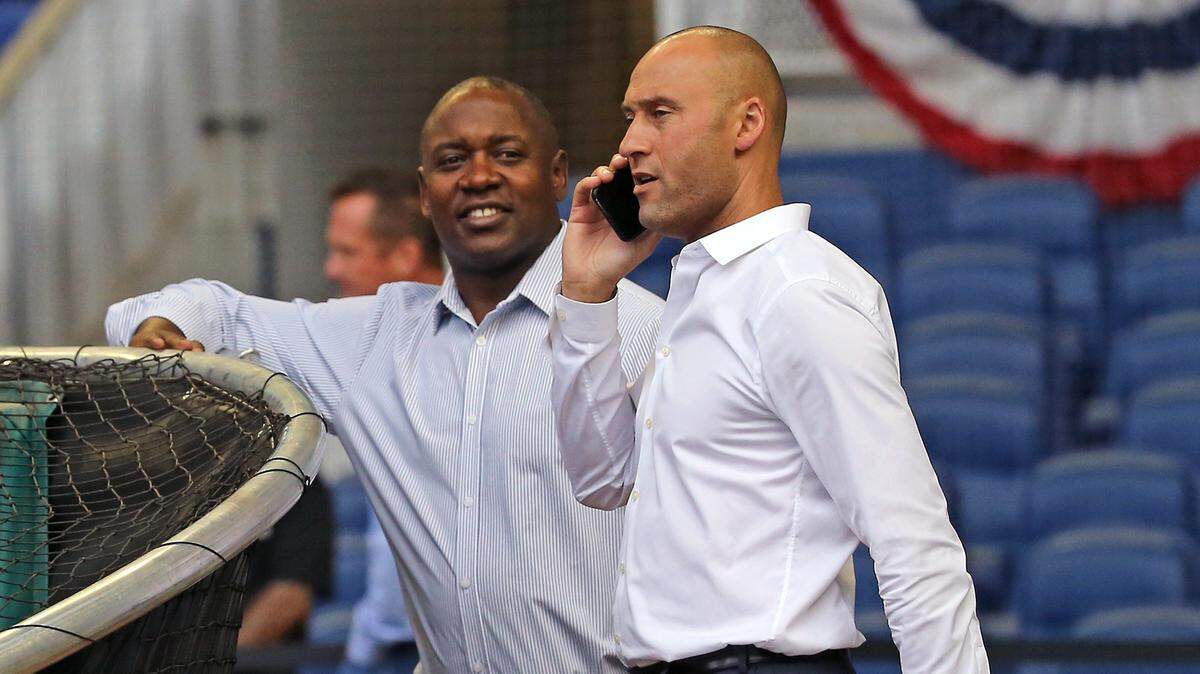 Miami Marlins president of baseball operations Michael Hill and Marlins CEO Derek Jeter talk during workout day ahead of Opening Day at the Marlins Park on Wednesday, March 27, 2019 in Miami.