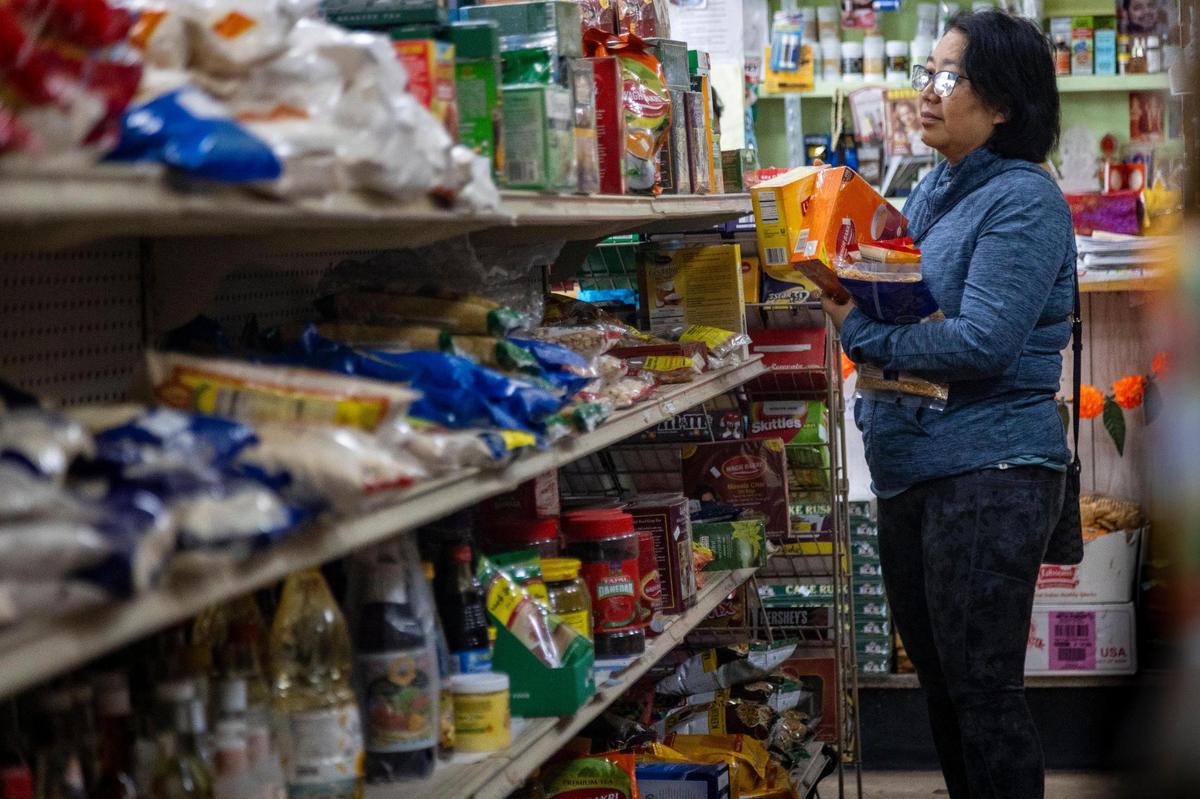 A customer takes advantage of the current going out of business sale at the Indo American Store in West Kendall. 