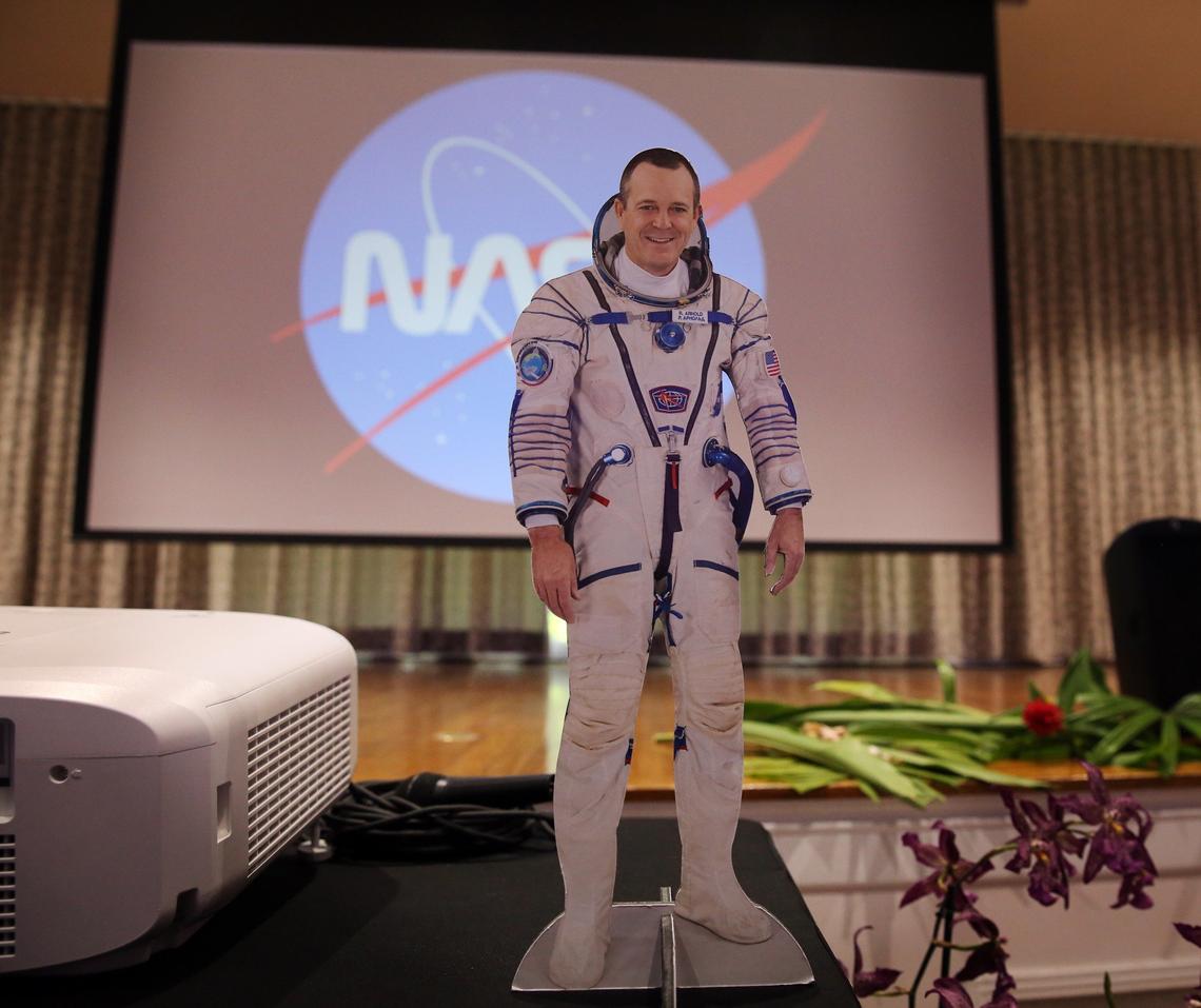 A mini, cut-out figure of astronaut  Ricky Arnold stands on a table top following a live, in-flight Education Downlink with astronauts aboard the International Space Station (ISS) on April 25, 2018, at Fairchild Tropical Botanic Garden in Coral Gables.