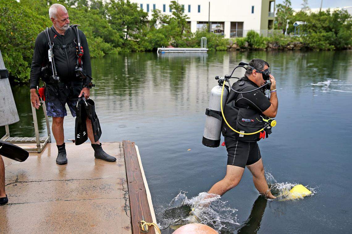 WAVES instructor Steve Rubin watches as military veteran Mauricio Valcarcel enters the water at the College of the Florida Keys in Key West, Florida, on Thursday, Oct. 22, 2020. WAVES, a nonprofit, was established by Rubin in 2012 to help veterans heal through scuba diving.
