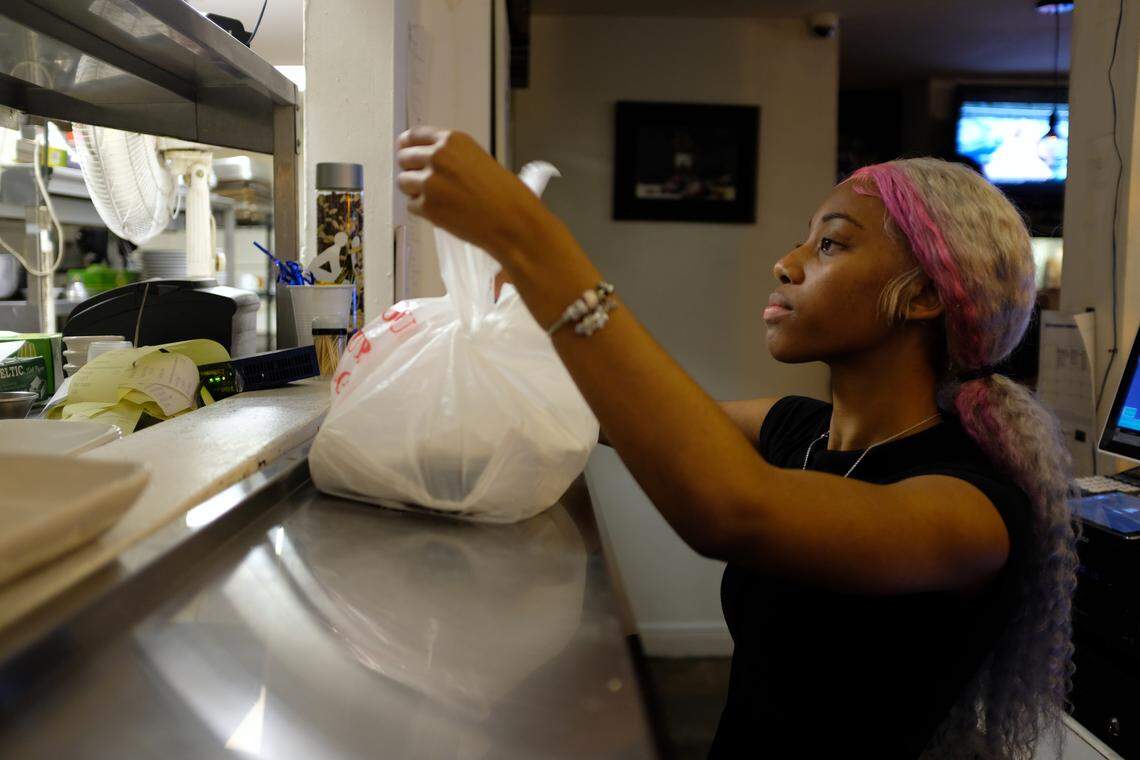 Korea, 16, helps put in orders and wait tables at her family’s Lil Greenhouse Grill in Overtown.