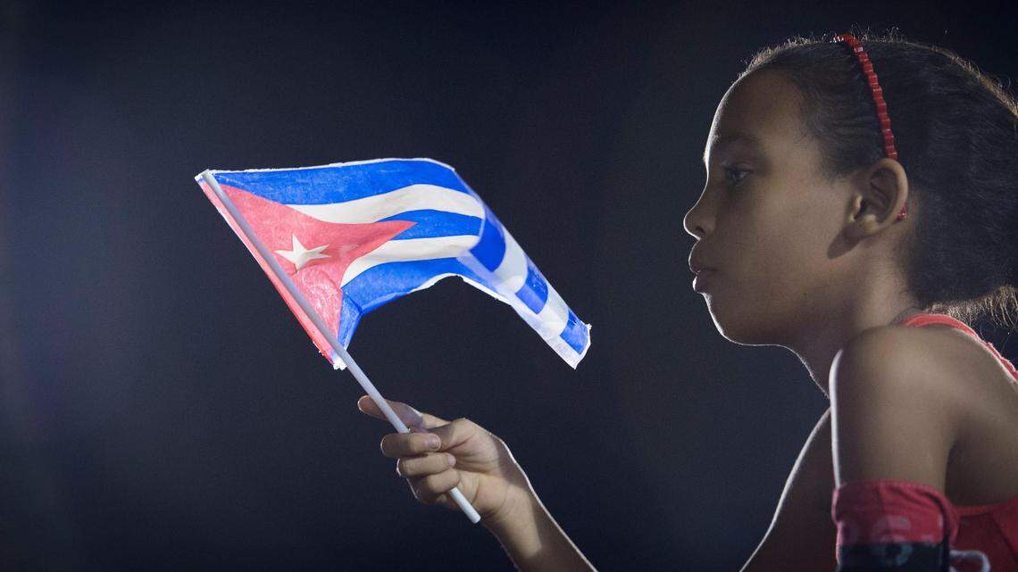 In 2016, attendees wave flags during the Fidel Castro memorial at the Plaza of the Revolution Antonio Maceo in Santiago de Cuba.