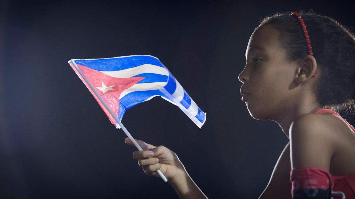 Dec 3, 2016; Santiago de Cuba, Cuba; Attendees wave flags during the Fidel Castro memorial at the Plaza of the Revolution Antonio Maceo in Santiago de Cuba. Mandatory Credit: Jack Gruber-USA TODAY NETWORK
