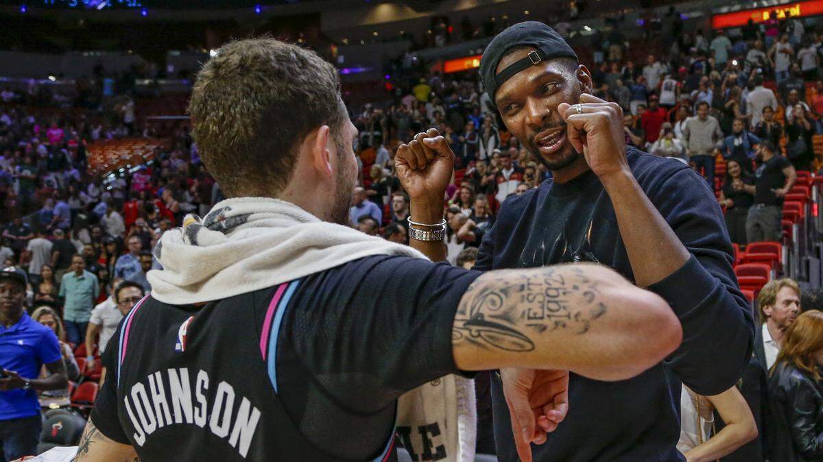 Former Miami Heat player Chris Bosh speaks with Miami Heat guard Tyler Johnson (8) after the game against the Washington Wizards at the AmericanAirlines Arena in Miami on Friday, January 4, 2019.