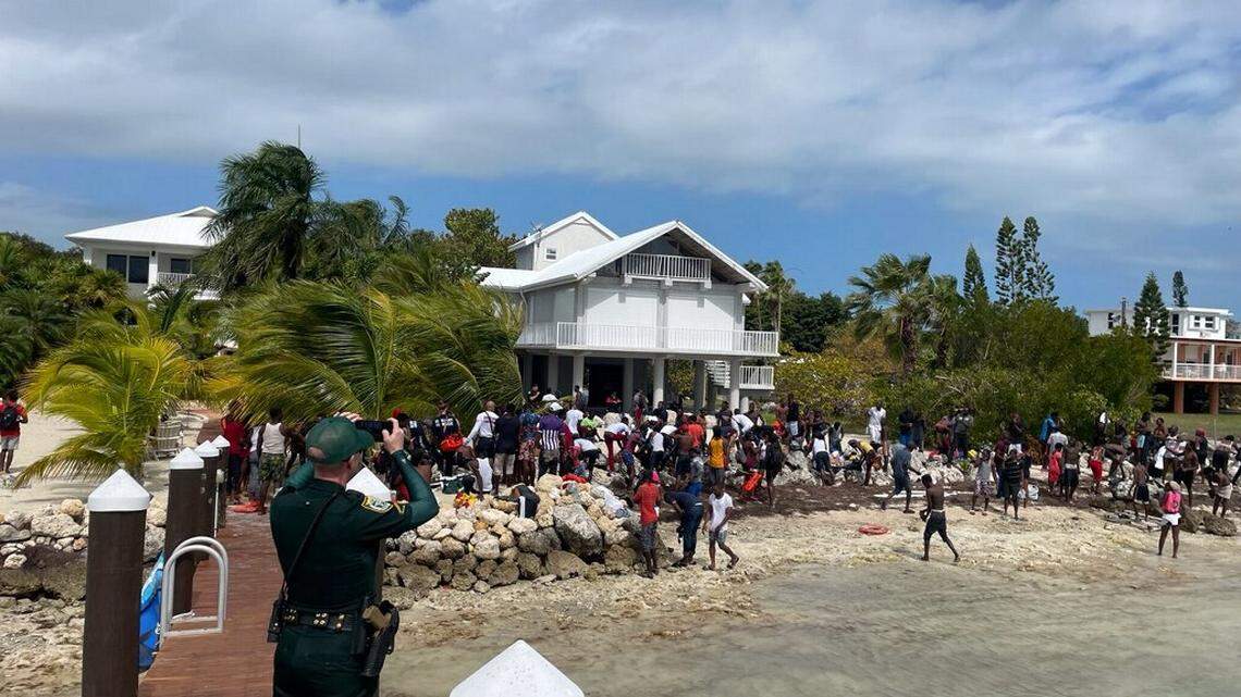 A large group of people from Haiti gather in a yard of an oceanfront home in Summerland Key in the Lower Florida Keys on Monday, March 14, 2022.
