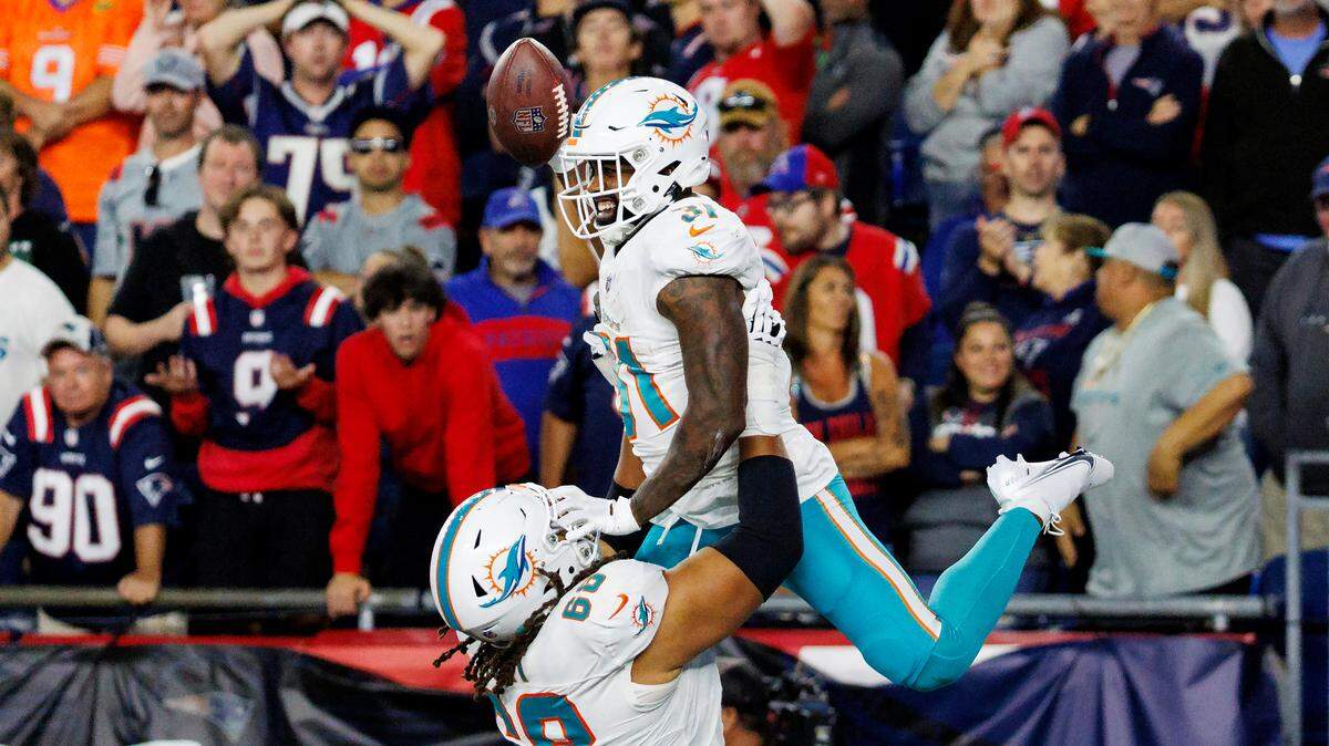Miami Dolphins running back Raheem Mostert (31) celebrates with teammate Robert Hunt (68) after scoring a touchdown against New England Patriots during fourth quarter of an NFL football game at Gillette Stadium on Sunday, Sept. 17, 2023 in Foxborough, MA.