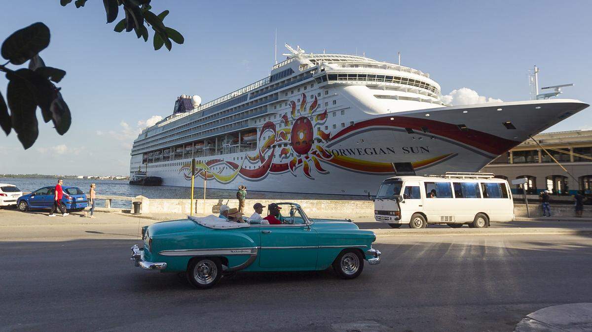 A classic car drives by a U.S. cruise ship at the port in Old Havana, Cuba, in November 2018.