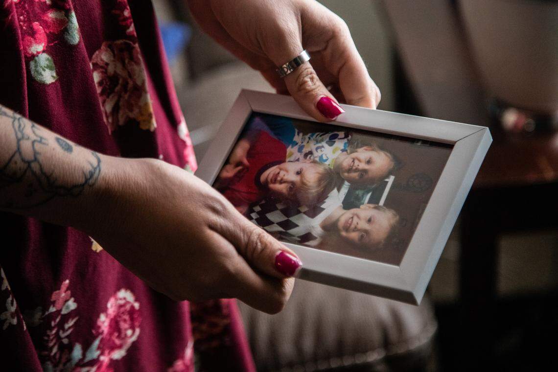 Amanda Simpson examines a photograph of her three children on Friday, Jan. 28, 2019, at her sister’s home in Chester, Virginia. Simpson’s ex-husband, Justin Tyler Painter, 39, shot and killed their three young children, Simpson’s boyfriend and then himself in Ponder, Texas, in May 2018.
