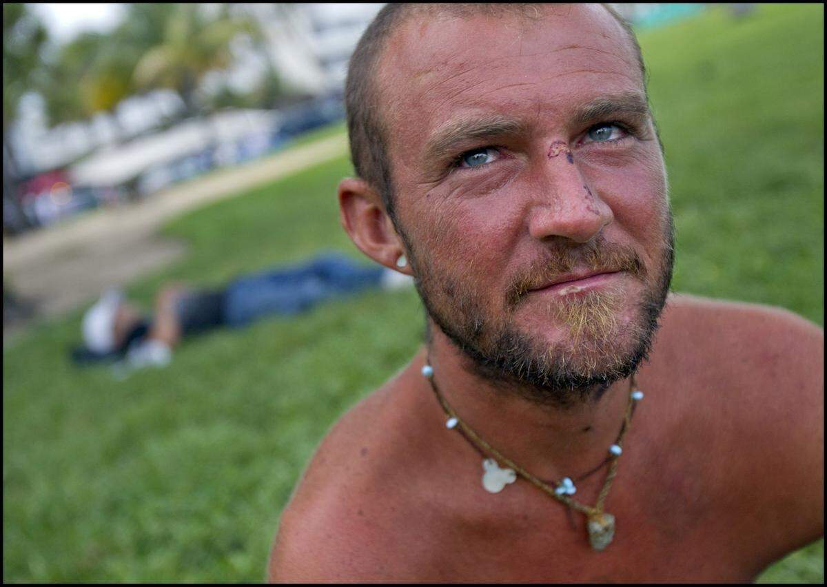 Jaime McNeil, 34, of California talks with officers from Homeless Outreach at Lummus Park in South Beach on Tuesday, June 25, 2013.