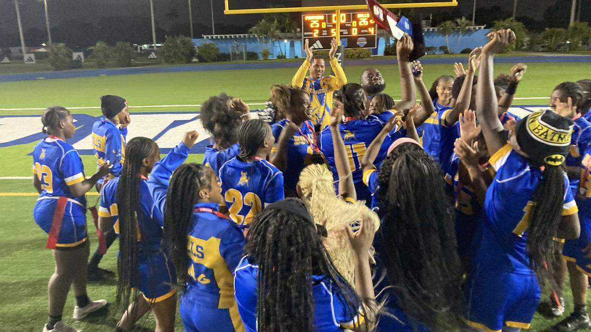 Miami Northwestern’s flag football players and coaches celebrate their first ever GMAC championship on Monday night at Traz Powell Stadium in Miami, Fla.