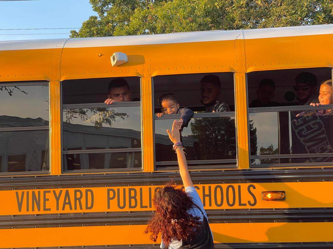 Children leaving say goodbye to a new friend as buses depart the Martha’s Vineyard high school on Wednesday, Sept. 14, 2022.