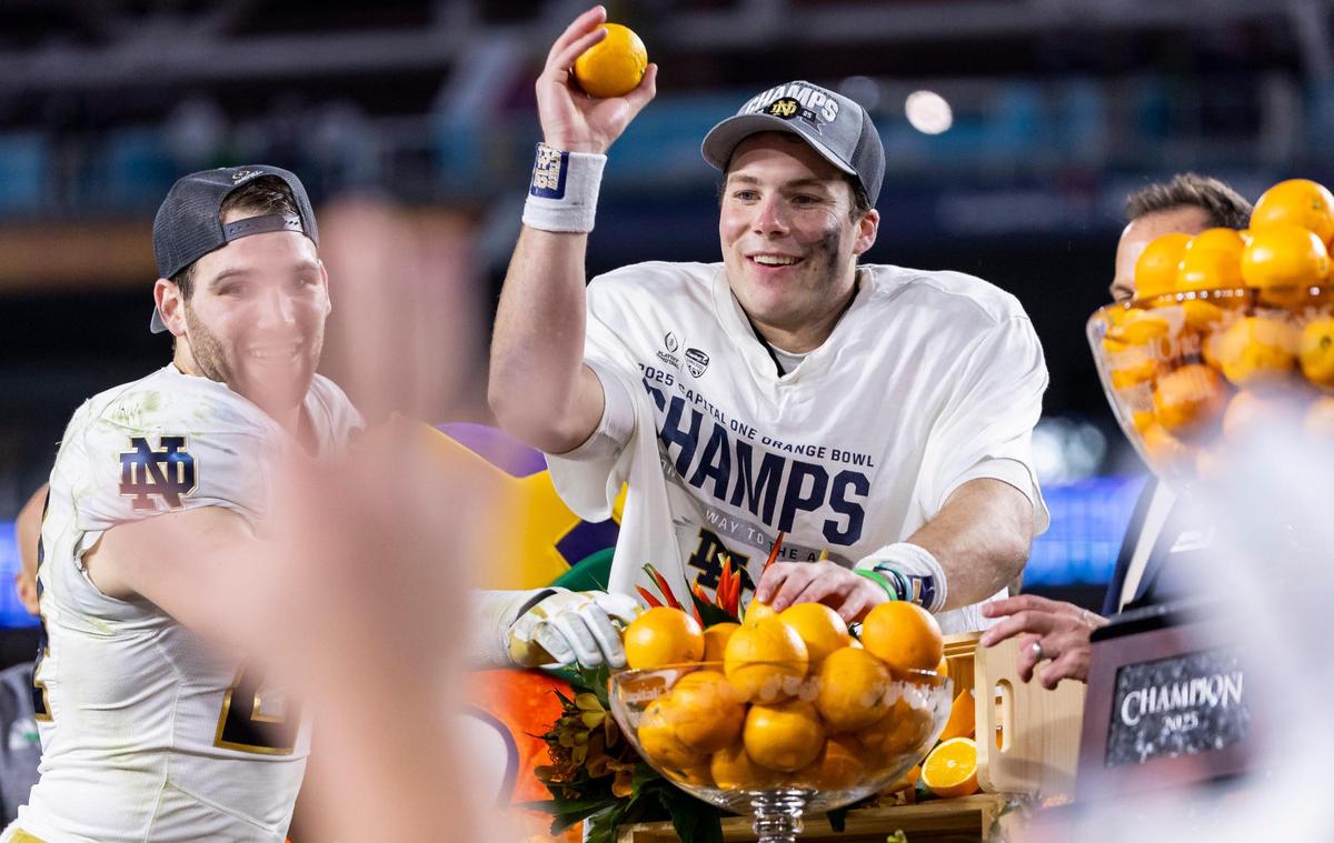 Notre Dame Fighting Irish quarterback Riley Leonard (13) throws oranges from the stage after defeating the Penn State Nittany Lions in their NCAA Playoff Semifinal Capital One Orange Bowl football game at Hard Rock Stadium on Thursday, Jan. 9, 2025, in Miami Gardens, Fla.