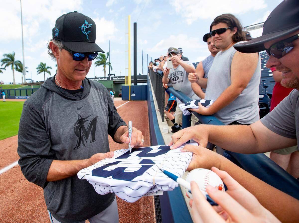 Miami Marlins manager Don Mattingly signs memorabilia for fans before the start of a Spring Training game against the Houston Astros at FITTEAM Ballpark of the Palm Beaches in West Palm Beach, Florida on Tuesday, February 25, 2020.