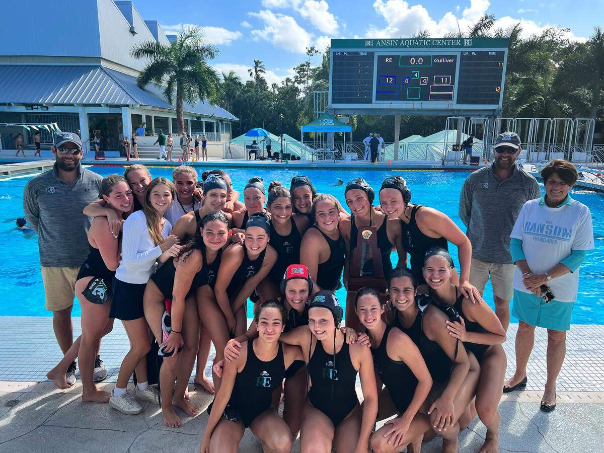 Ransom Everglades’ girls’ water polo team celebrates its regional title after a 12-11 victory over rival Gulliver Prep on Tuesday afternoon. The Raiders advanced to the state final four.