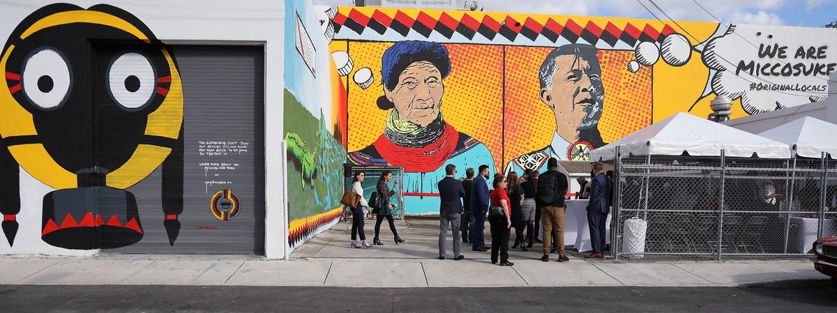 Native American artist Bunky Echo-Hawk stands near his mural created for the Miccosukee Tribe of Indians to showcase their history and preservation of the Everglades. The mural, unveiled Thursday in Wynwood, will be on display during Miami Art Week and Art Basel, beginning Dec. 2.