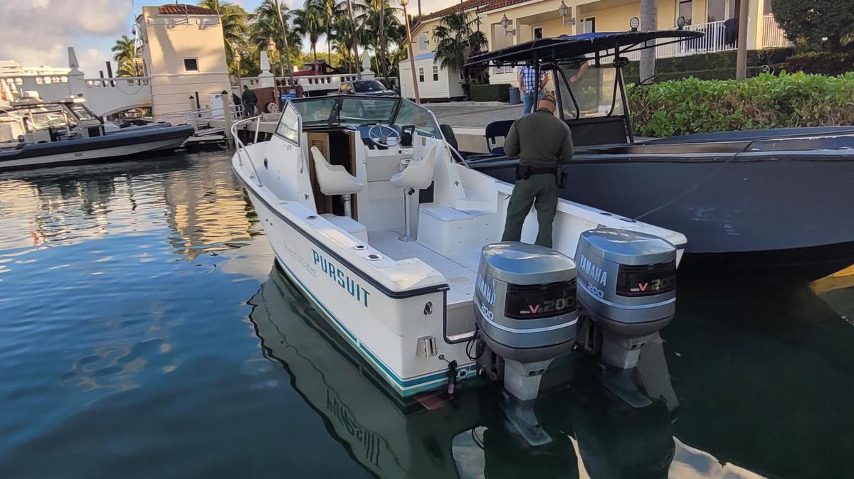 A twin-engine cabin cruiser is docked near Haulover Marina Wednesday, Feb. 1, 2023. Border Patrol officials say the boat had six migrants from three different countries on board.