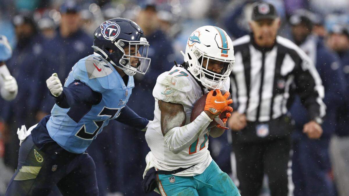 Miami Dolphins wide receiver Jaylen Waddle (17) makes a catch as he is defended by Tennessee Titans safety Amani Hooker (37) in the second half of an NFL football game Sunday, Jan. 2, 2022, in Nashville, Tenn. (AP Photo/Wade Payne)