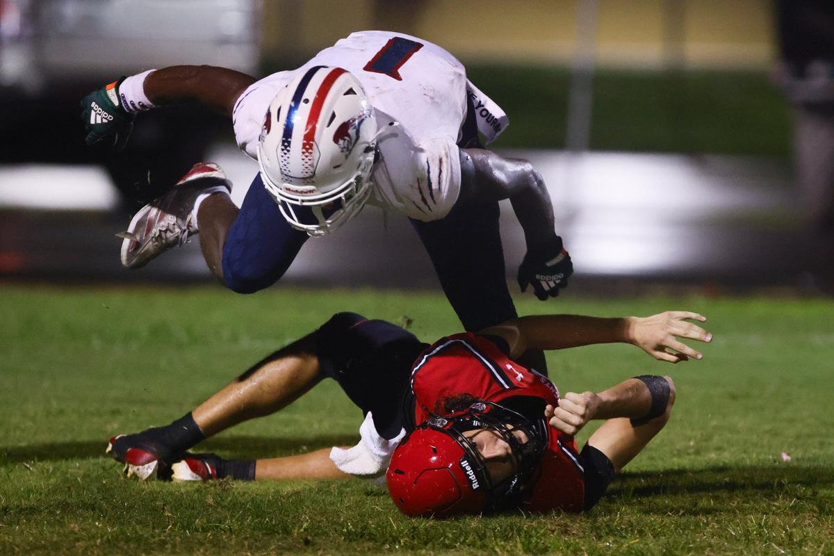 Chaminade-Madonna Lions Derrek Cooper (1) sacks Monarch Knights quarterback Jack Spaeder (18) inside the end zone for a safety during the second quarter of a high school football game at Coconut Creek High School in Coconut Creek, Florida, Saturday, October 5, 2024.