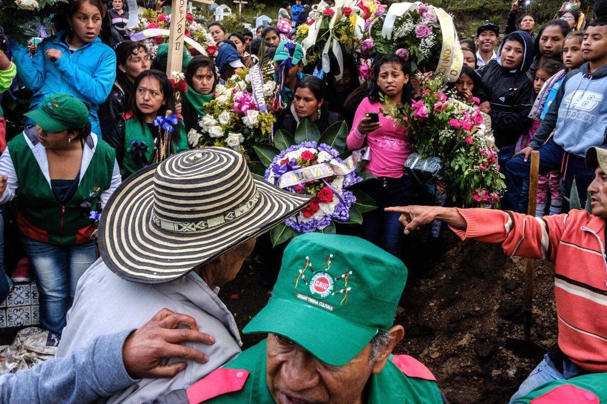 Community members and the Indigenous Guard of the Kokonuko people bury Efigenia Vasquez, a Kokonuko social communicator and journalist, who was killed on a hillside during the community’s attempt to reclaim their ancestral land under private ownership. Coconuco, Cauca, Colombia. Oct. 11, 2017.