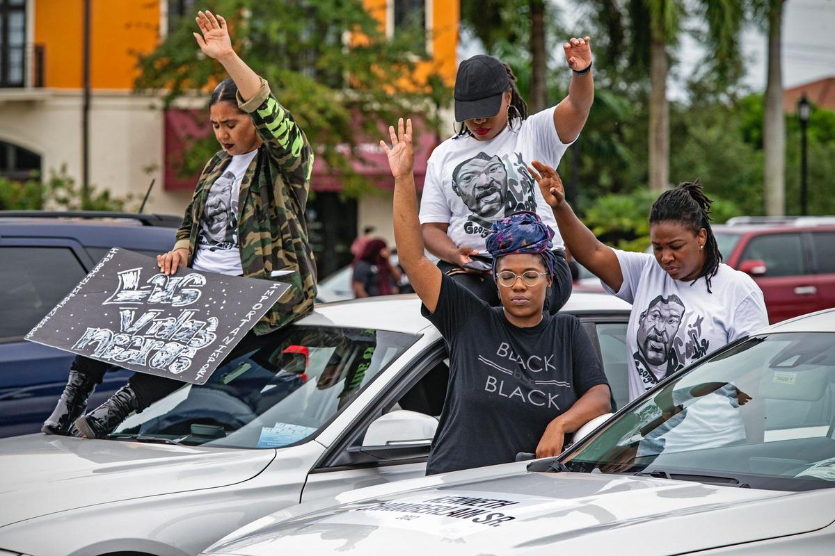 Demonstrators pray at Miramar Town Center after mock funeral procession on Wednesday, June 3, 2020, in the wake of the death of George Floyd and for all victims of police and racial violence.
