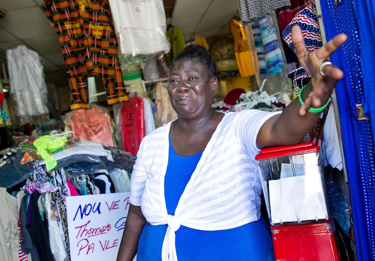 Marie Jeannine Desir cries on April 26, 2018 as she explains that the developer who bought the shopping center where her store is located wants to evict her, even though she paid her rent on time.