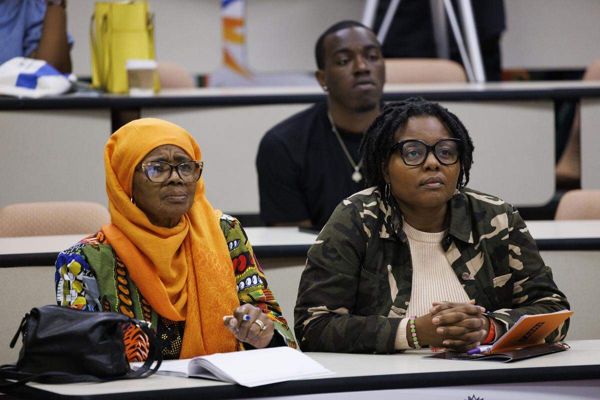 Dr. Patricia Salahuddin, left, and Dr. Valencia Copeland, who was Salahuddin former middle school student, listen to Dr. Alexia Rolle give a presentation on Alternative Paths to Success during the Teach to Fish Business Summit, on Tuesday, Oct. 14, 2025, at the Kovens Conference Center in North Miami Beach, Fla.