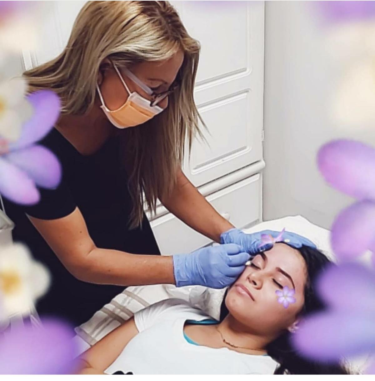 Miami cosmetologist Doris Roblero works on a client in a photo taken before she stopped working due to the new coronavirus pandemic.