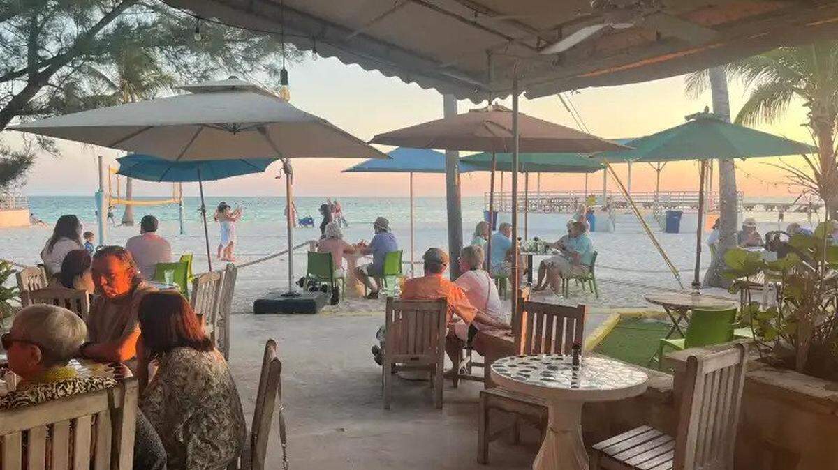 Diners enjoy a waterfront sunset at Salute! on the Beach in Key West, which was just named one of the best beachfront restaurants in Florida.