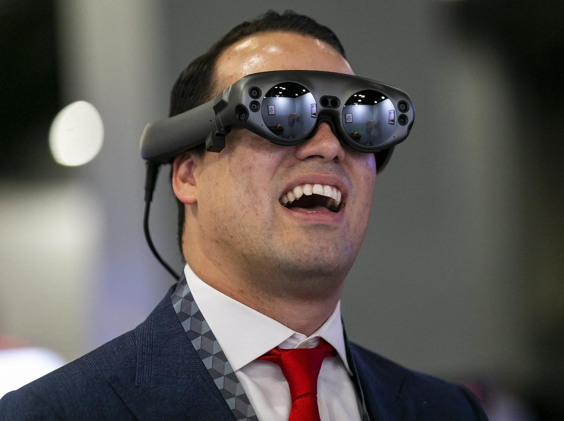 Gabriel Llaurado, 32, reacts while wearing the Magic Leap headset during the technology conference, eMerge Americas, inside the Miami Beach Convention Center in Miami Beach, Florida on Monday, April 29, 2019. Magic Leap is a head-mounted virtual retinal display.