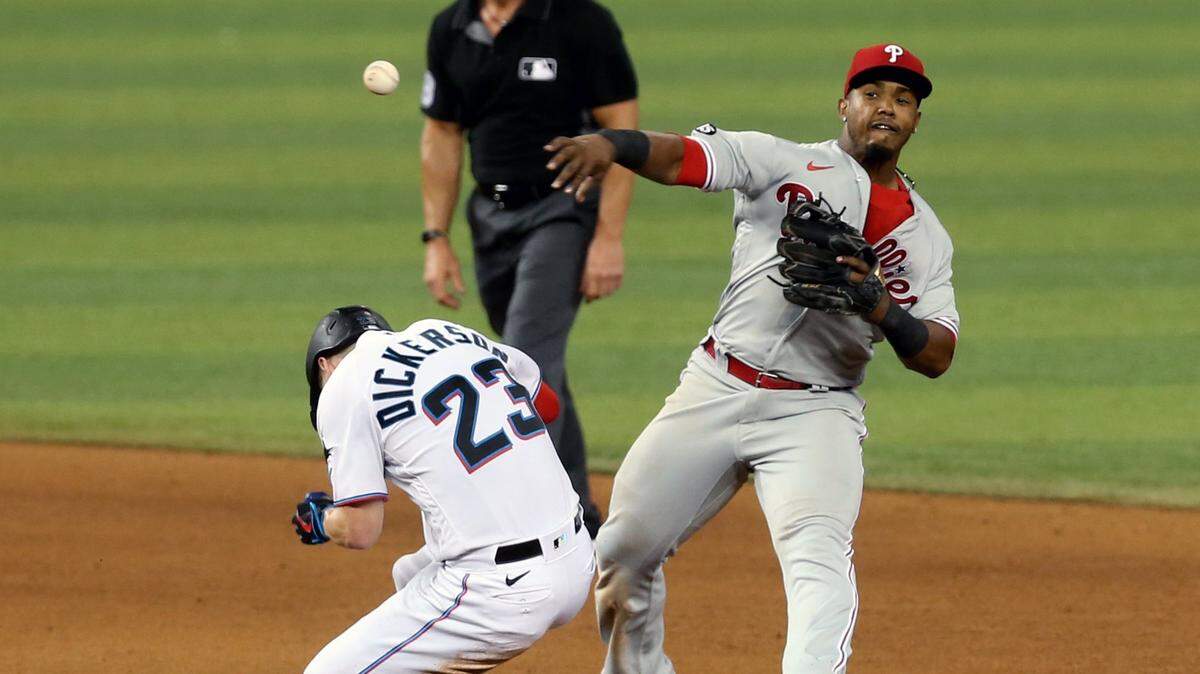 Miami Marlins Corey Dickerson (23) slides safely into second base as Philadelphia Phillies second baseman Jean Segura( 2) throws to first base in the eighth inning at loanDepotpark in Miami, Florida, May 26, 2021.