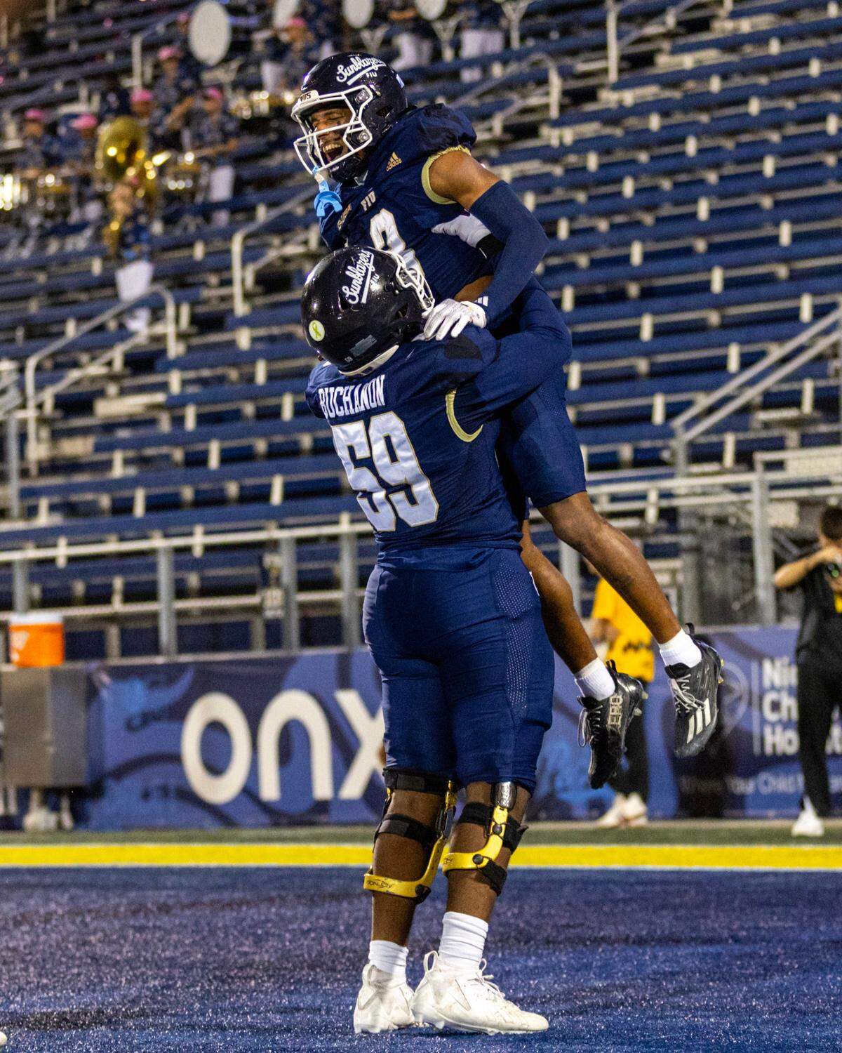 Florida International University Panthers wide receiver Eric Rivers (3) celebrates with lineman Jaheim Buchanon (59) after scoring a touchdown during the second half of an NCAA Conference USA football game against the New Mexico State Aggies at Pitbull Stadium on Tuesday, October 29, 2024, in Miami, Fla. 
