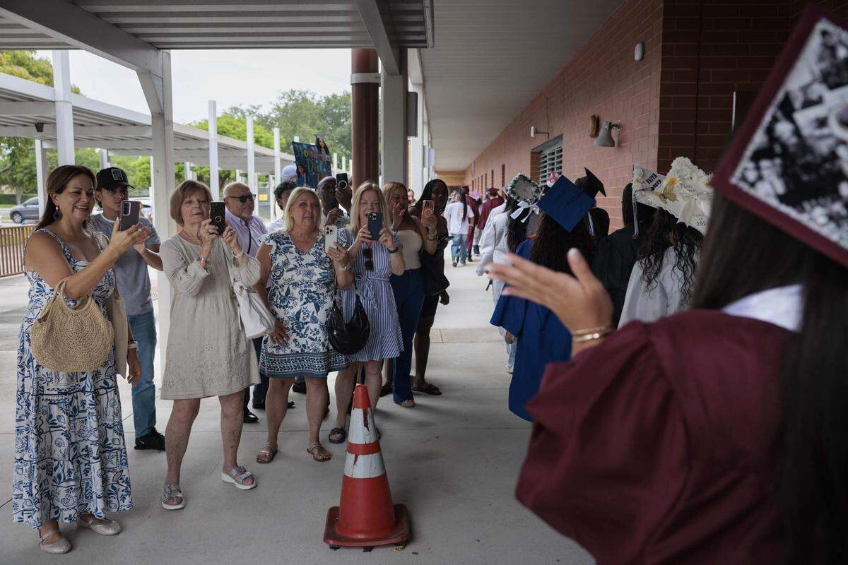 Parents clap for their high school graduates from all over Broward as they walk through the halls of their elementary school, Panther Run Elementary, on Monday, June 1, 2026, in Pembroke Pines, Fla. The school invited graduating alumni, from as far as Illinois, to come and walk through their former elementary school to celebrate their high school graduation before it closes. 