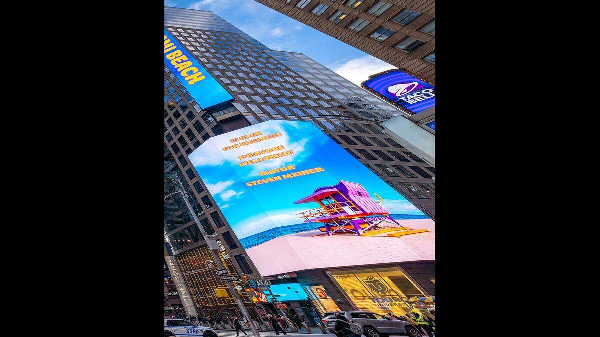 In a billboard that displayed in New York’s Times Square, Miami Beach Mayor Steven Meiner encouraged people to come to his city.