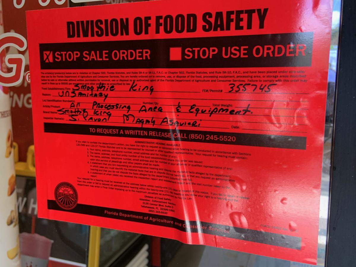 Under the brown covering on the door of the Miami Lakes Smoothie King, the citation from the Florida Department of Agriculture.