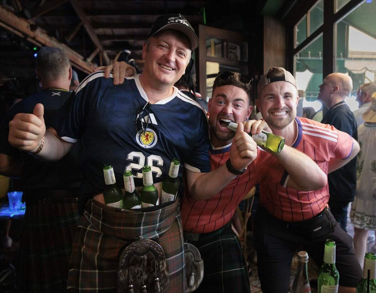 Charlie Sinclair, from Scotland, left, Matthew mackenzie, center, and Jaye Sinclair pose during a gathering of Tartan Army, Scottish National Football team fans, at Ball & Chain on Monday, June 22, 2026, before a parade down Calle Ocho in Miami, Fla.