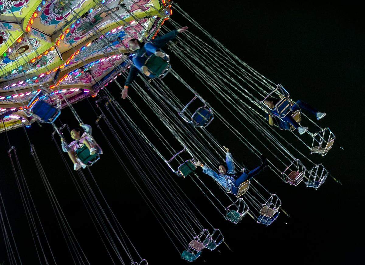 Guests ride on an attraction during the opening day of the Miami-Dade County Youth Fair in Miami, Florida on Thursday, Nov. 18, 2021.