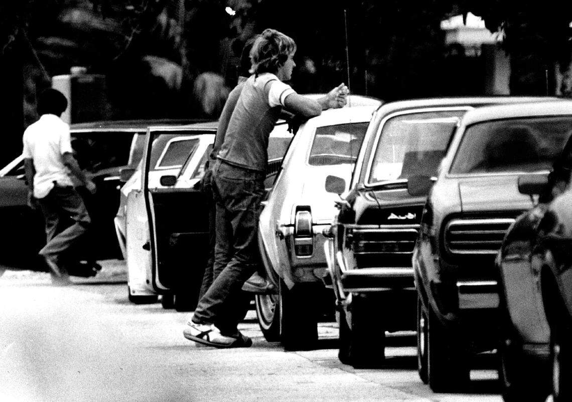 Student stand by their cars in the Coral Gables High parking lot in 1978.