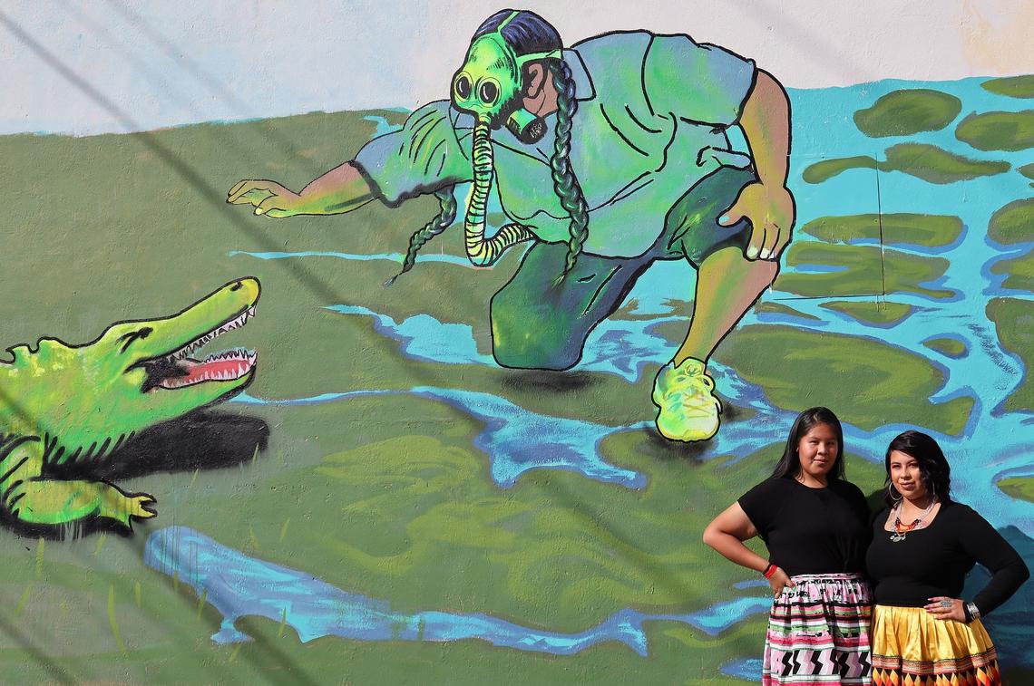 Sisters Katrina, left, and Angel Bowers, stand near the Native American artist Bunky Echo-Hawk’s mural commemorating the Miccosukee Tribe of Indians during its unveiling Thursday morning, Nov. 21, 2019, in Miami’s Wynwood neighborhood.