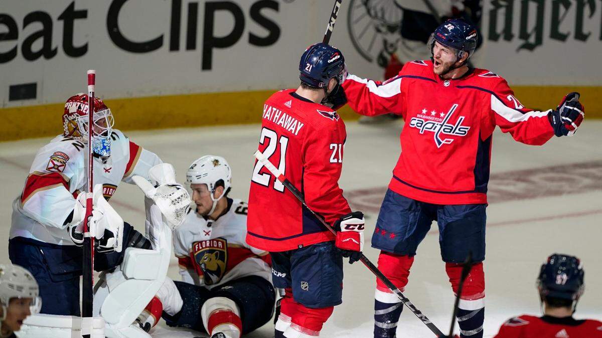 Washington Capitals right wing Garnet Hathaway and center Nic Dowd, right, celebrate Hathaway’s goal past Florida Panthers goaltender Sergei Bobrovsky, left, during the third period of Game 3 in the first-round of the NHL Stanley Cup hockey playoffs, Saturday, May 7, 2022, in Washington. The Capitals won 6-1. (AP Photo/Alex Brandon)