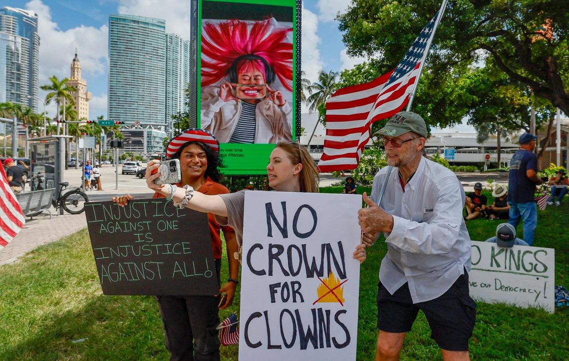 Valarie Bunge, 34, and Bob Remmen, 74, take a selfie during a ‘No Kings’ anti-Trump protest at the Torch of Friendship monument at Bayfront Park in Miami, Florida on Saturday, June 14, 2025