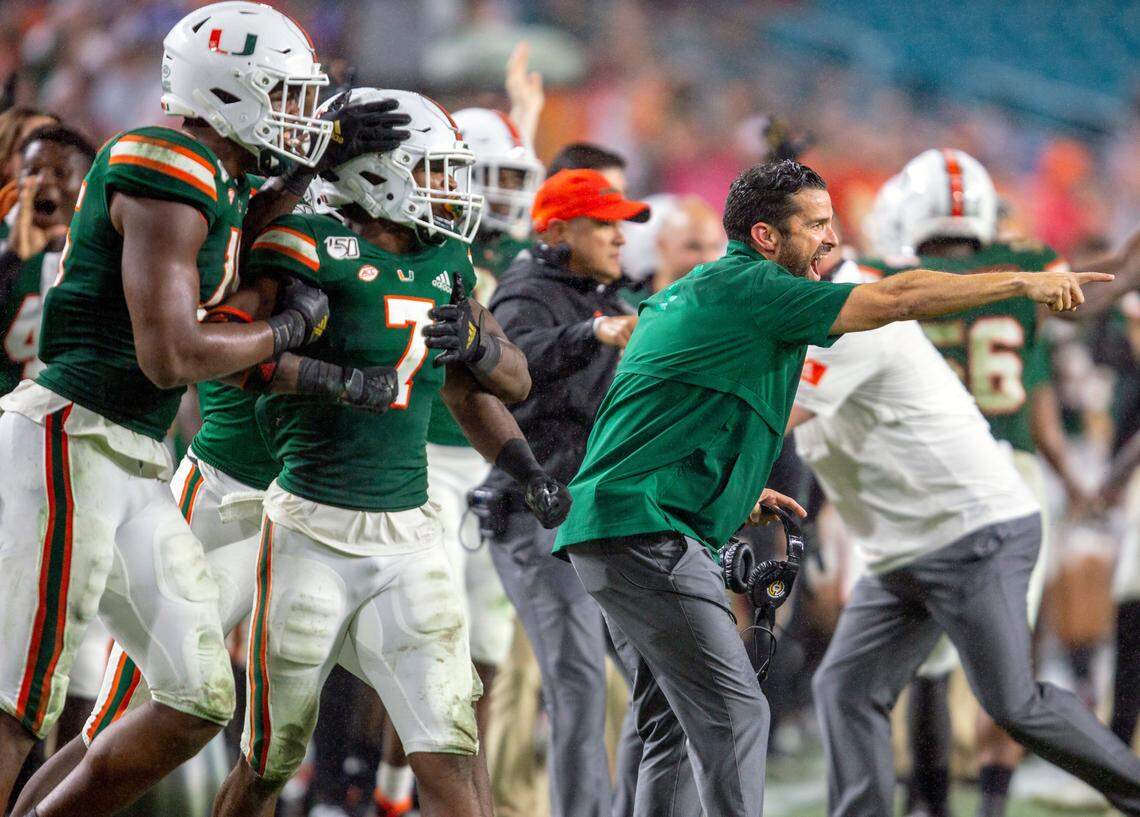 Miami Hurricanes head coach Manny Diaz and the Canes sideline react after a recovered fumble by Jimmy Murphy (29) during the third quarter of a football game against Louisville at Hard Rock Stadium in Miami Gardens, Florida on Saturday, November 9, 2019.