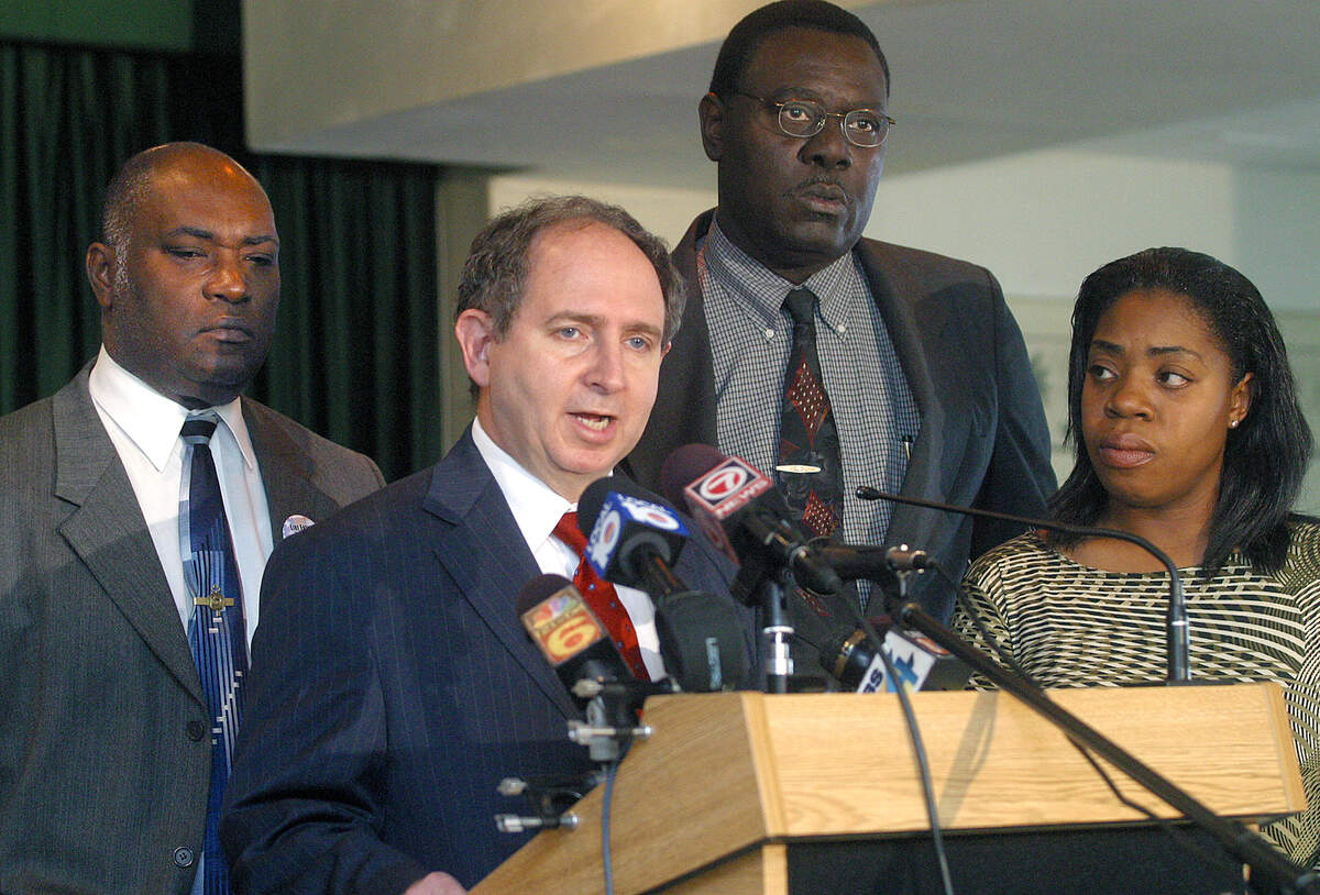 Shirlee Moreau Lafleur, right, deputy district director for U.S. representative Kendrick Meek looks on as Ira J. Kurzban, a Miami attorney representing an exiled Haitian president Jean-Bertrand Aristide, speaks at a March 1, 2004, press conference. To his left is North Miami Councilman Jacques Despinosse and to his right is North Miami Beach Councilman Philippe Derose.