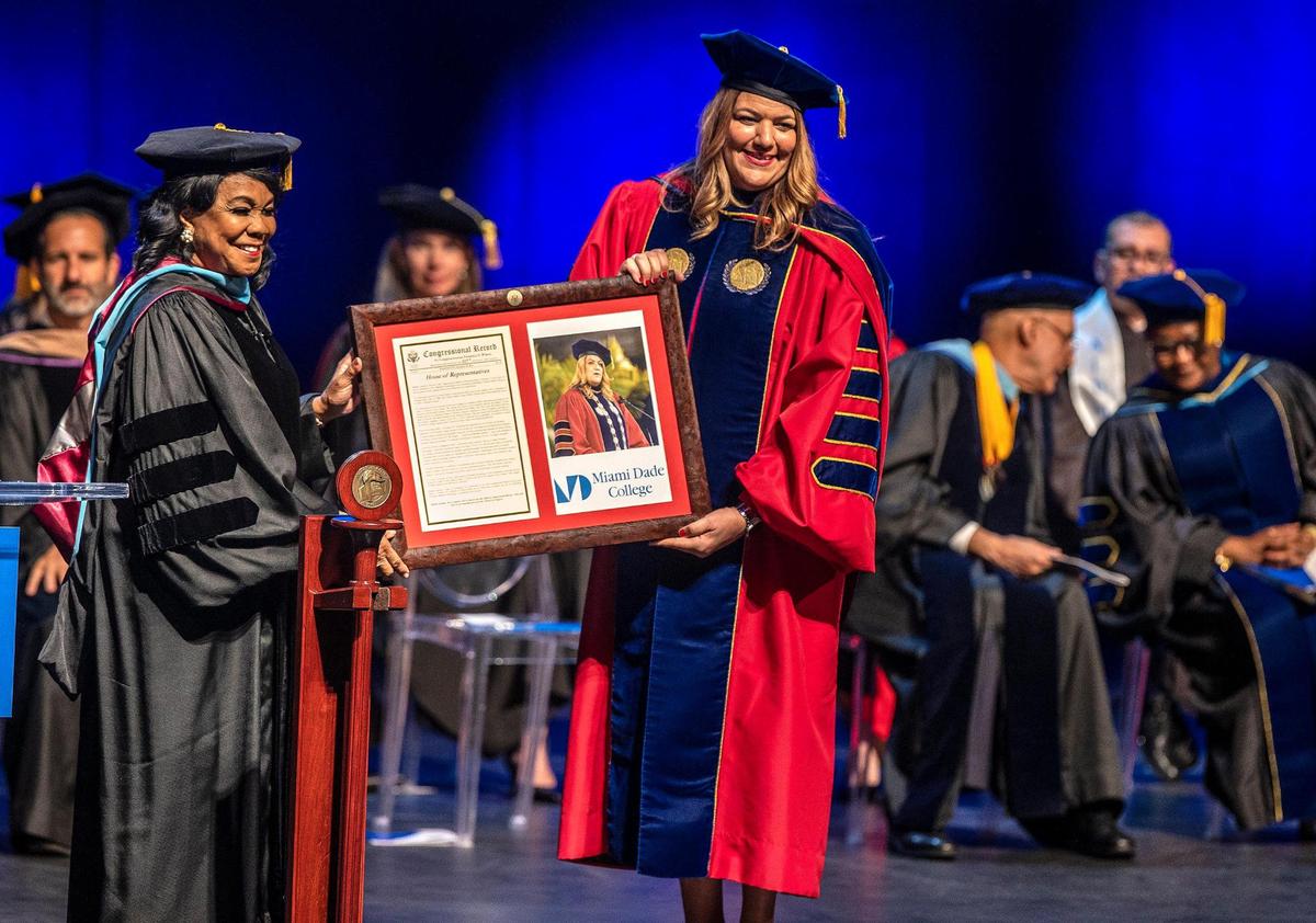 U.S Rep. Frederica Wilson, left, presents a congratulatory declaration that will be preserved at the U.S Library of Congress to new MDC President Madeline Pumariega on Friday, Dec. 10, 2021.