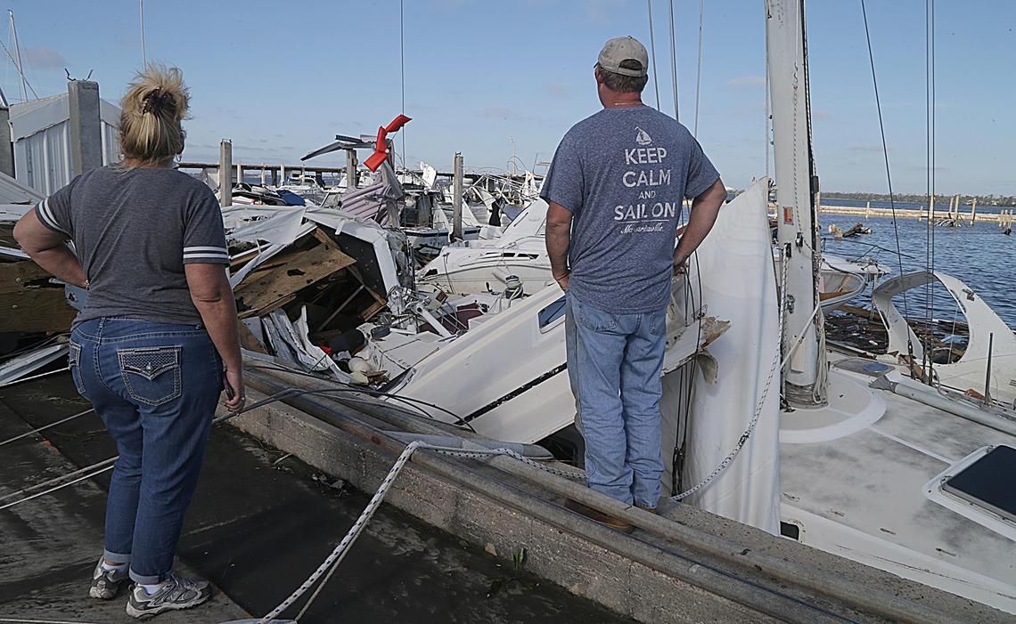 Teresa and Randall Jones look over shattered boats. including their own named Fear Knot, early Thursday morning at the City Marina, the day after Hurricane Michael hit Panama City as a Category 4 hurricane in the Florida Panhandle.