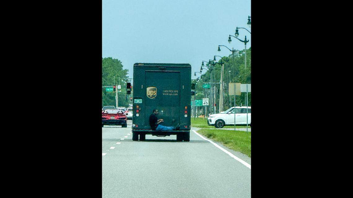 A 911 caller reported a man was riding on the back of a UPS truck in Palm Coast, Florida, leading to an unusual arrest, the Flagler County Sheriff’s Office says.