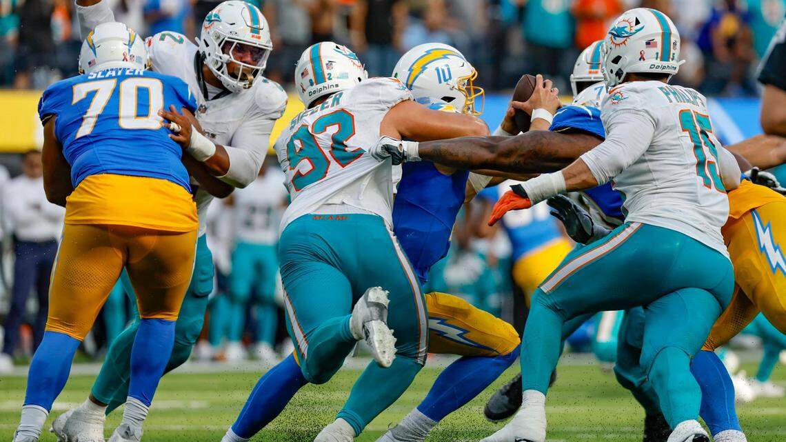 Miami Dolphins defensive tackle Zach Sieler (92) and the Dolphins defense sack Los Angeles Chargers quarterback Justin Herbert (10) late in the fourth quarter at SoFi Stadium in Inglewood, California on Sunday, September 10, 2023.