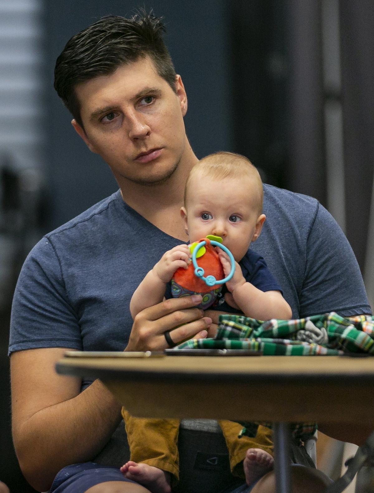 Alex Akulov and his 6-month-old son, Maxim, attend a free meetup group for Amazon resellers in Miami on Saturday, December 15, 2018. The free Meetup aims to teach members how to successfully launch and sustain a business selling items on Amazon.